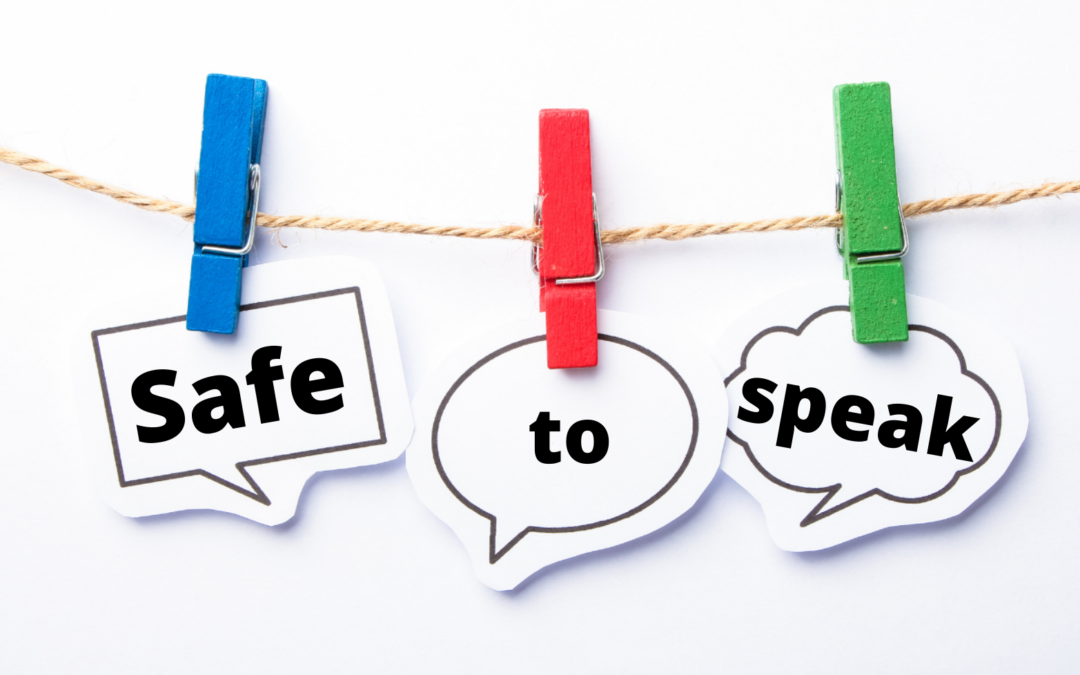 Safe - To - Speak - words on Three speech bubbles held up by clothes pegs on string
